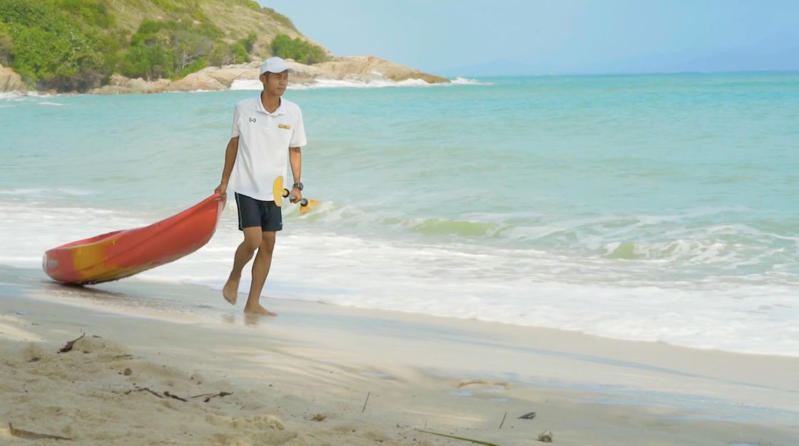 A kayak carried down to the beach