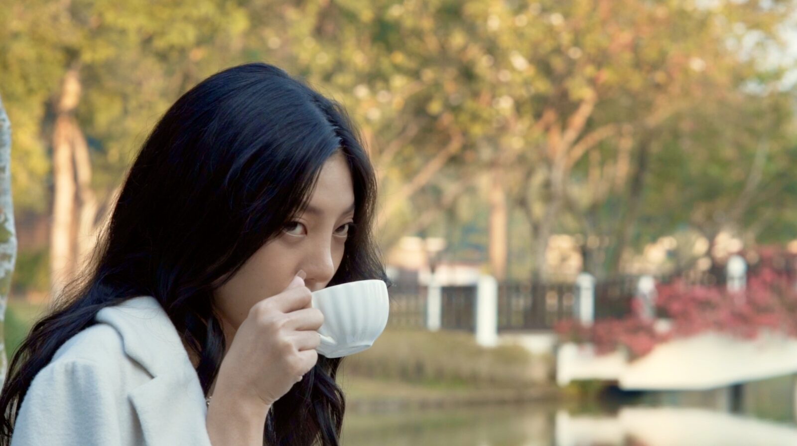 Guest with morning tea in tropical gardens — hotel filming in Southeast Asia