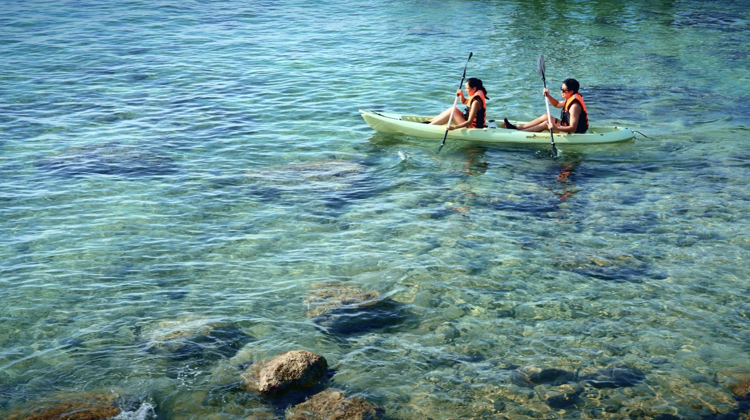 Kayaking over the reef in clear water