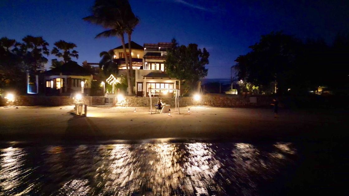 The beachfront resort lit after dark