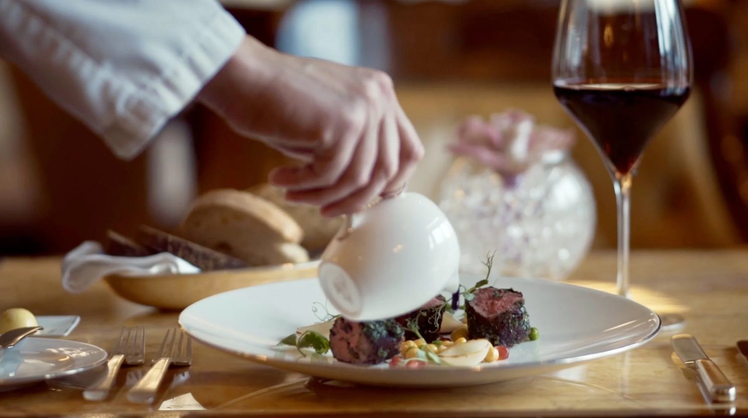 A plated course set against the wine