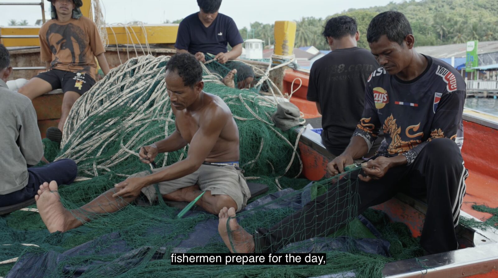 Fishermen prepare their nets for the day