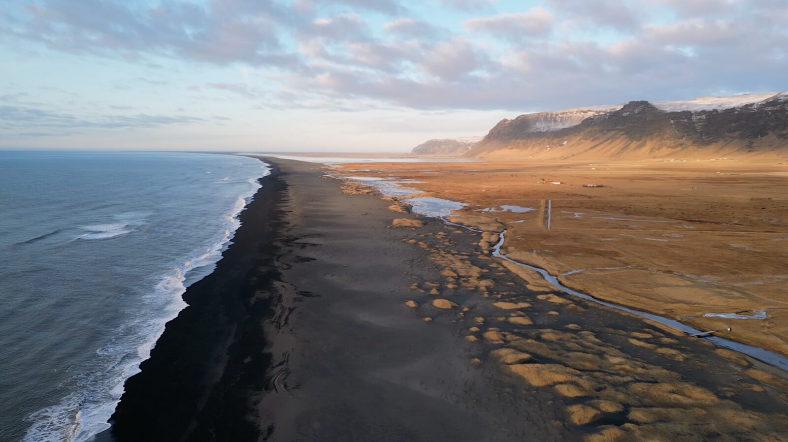 The black-sand coastline from above