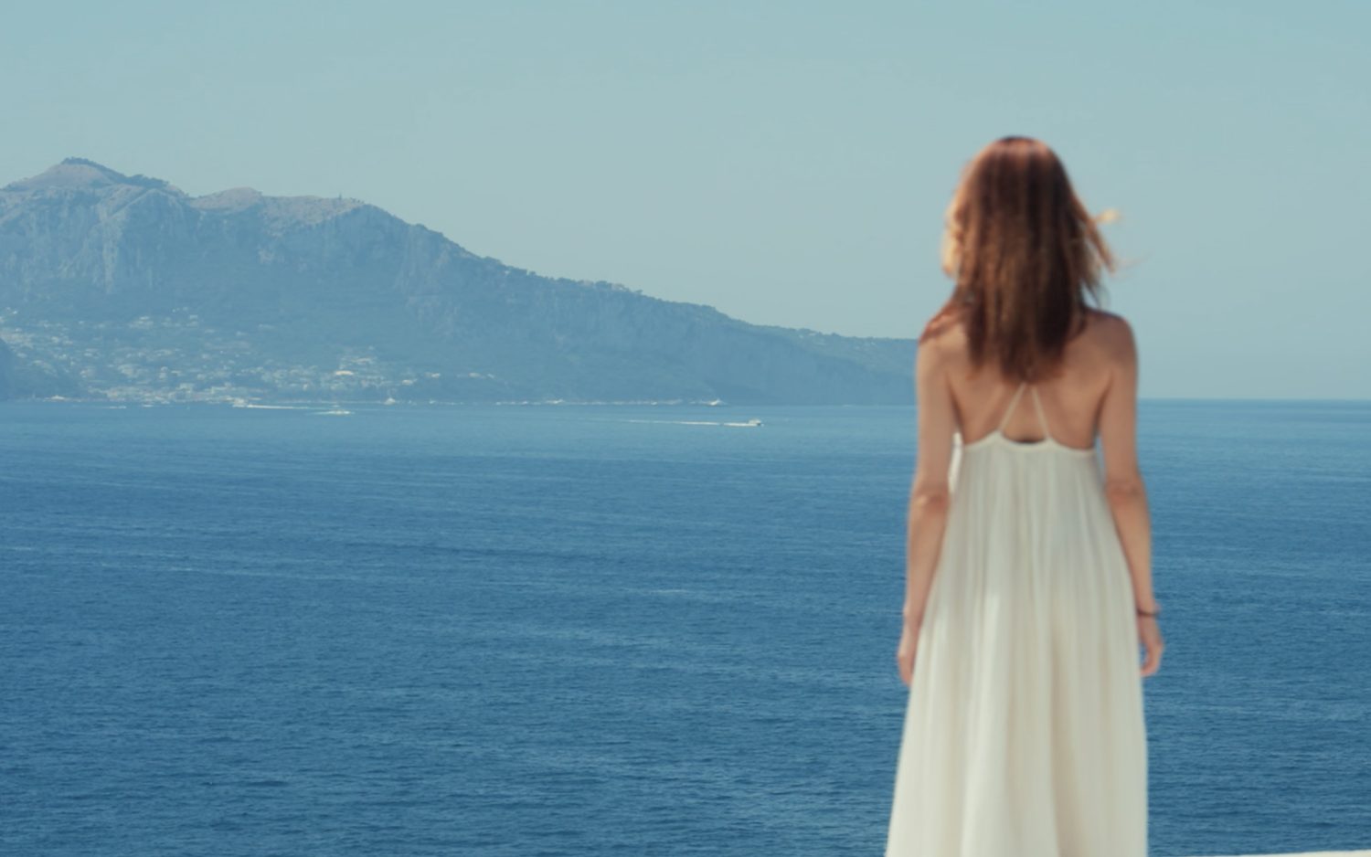 A figure on the terrace looking across to Capri